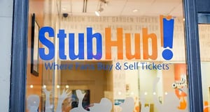 StubHub storefront window with ‘StubHub! Where Fans Buy & Sell Tickets’ sign—illustrating the legacy resale model before digital ticket-license control.